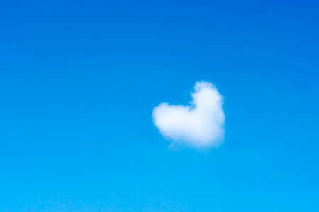 Heart shape cloud in the blue sky.の写真素材