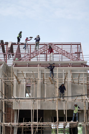 Unidentified workers are working on the construction site.