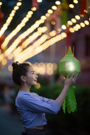 CHIANG-MAI, THAILAND. 8 OCTOBER 2023 : Asian women holding a traditional paper lantern during Yi...