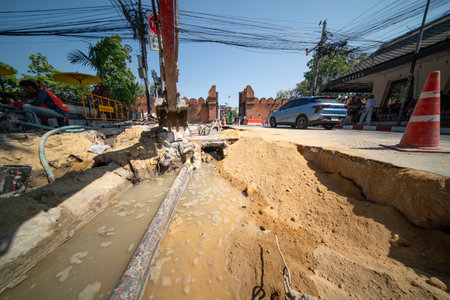 CHIANG MAI, THAILAND FEBRUARY 12, 2024 : Technicians are laying electrical wiring in Chiang-Mai city main road.のeditorial素材