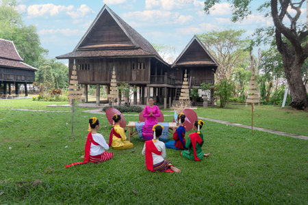 THAILAND - CHIANG-MAI, 11 MAY 2024 : A teacher is teaching Thai dance to students in a Thai style house.のeditorial素材