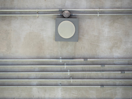 The installation of a electric wire system in steel pipes for the building on cement wall.