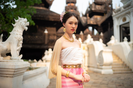 Beautiful young Asean woman in traditional Thai Dvaravati dress in an old temple in Chiang Mai, Thailand.の写真素材