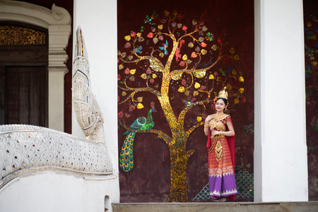 Beautiful young woman wearing Thai Songkran costume, a regional Thai costume dress in Chiang Mai,...