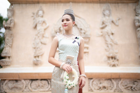Beautiful young Asian woman in traditional Thai Dusit dress in an old temple in Chiang Mai, Thailand.の写真素材