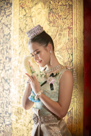 Beautiful young Asian woman in traditional Thai dress in an old temple in Chiang Mai, Thailand.の写真素材