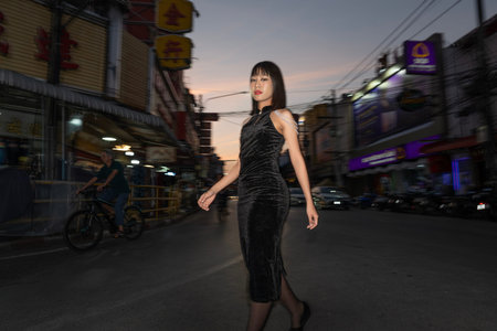 Young women from ASEAN countries, stand in front of a shrine in Kad Luang Market, Chiang Mai Province.の写真素材