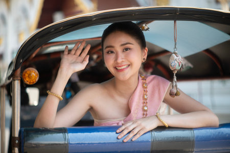 Young women from ASEAN countries wear Contemporary Thai dresses with jeans as a fashion trend in Chiang Mai.の写真素材