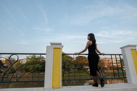 Young women from ASEAN countries stand in front of a shrine in Kad Luang Market, Chiang Mai Province.の写真素材