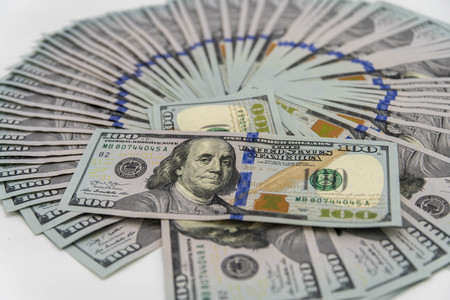 a stack of us 100 dollars cash with white background
