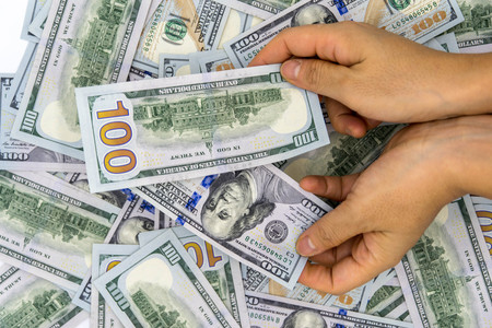 Pick up 100 us dollar white background