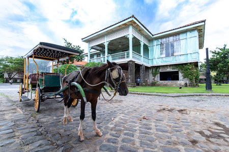 A carriage standing in front of a Spanish-style house,Bataan, Philippinesのeditorial素材