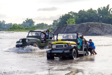 CAPAS , PHILIPPINES - July 8, 2018 : People pushing cars in the river