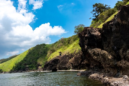 A person jumping from a cliff into the sea, Batan, Philippines