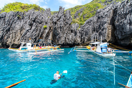 Nov 18,2018 Boats waiting people at outside Secret Beach in El nido, Palawan, Philippinesのeditorial素材