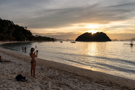 Beautiful sunset on the Maremegmeg Beach at El Nido, Palawan, Philippinesの写真素材