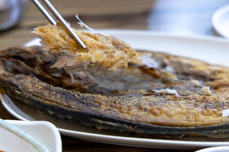 Korean food - Grilled mackerel with chopsticks