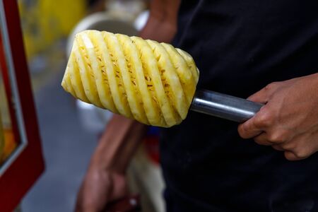 A man holding a peeled pineapple, Manila, Philippinesの写真素材