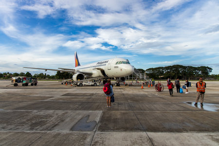 Dec 14, 2019 Passengers on an airplane at Dumaguete airport, Dumaguete city, Philippinesのeditorial素材