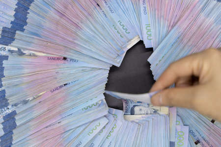 A pile of one thousand Philippines banknotes. Cash of Thousand dollar bills, Peso background image.の写真素材