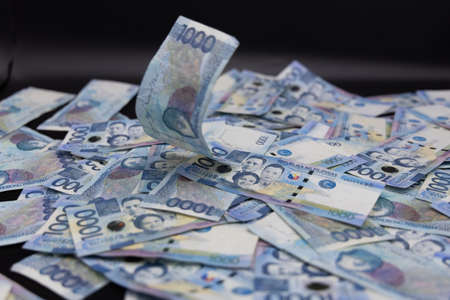 A pile of one thousand Philippines banknotes. Cash of Thousand dollar bills, Peso background image.