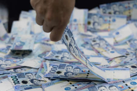 A pile of one thousand Philippines banknotes. Cash of Thousand dollar bills, Peso background image.