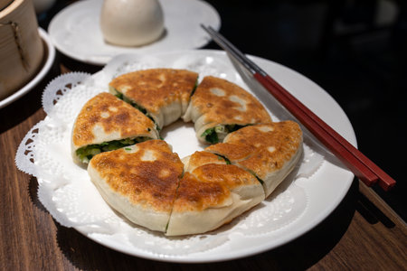 Chinese bun pan cake on a white plate in a restaurant