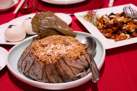 Chinese Seafood Fried Rice Wrapped in Lotus Leaves on the tableの写真素材