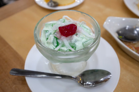 Traditional Filipino desserts Buko Pandan Salad with spoonの写真素材
