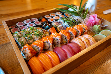 Tuna, Salmon Sushi and California roll on the table at Japanese restaurantの写真素材