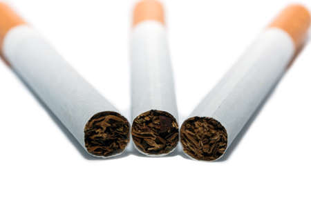 Three cigarettes at white backgroundの写真素材