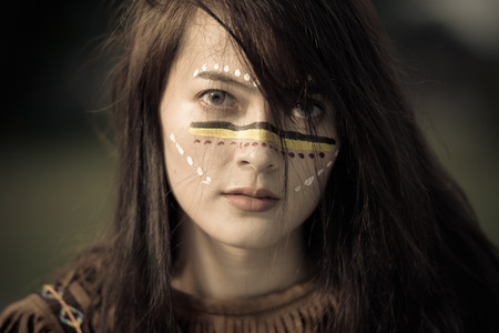 Cowgirl on during sunset. Relaxing, enjoying sitting on a haystack in a horse farm. Vintage tone.の写真素材