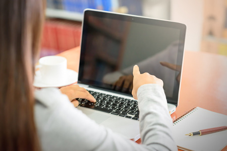 Young businesswoman using a laptop computer. Business and Technology Concepts.の写真素材