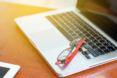 The glasses are on a laptop computer.の写真素材