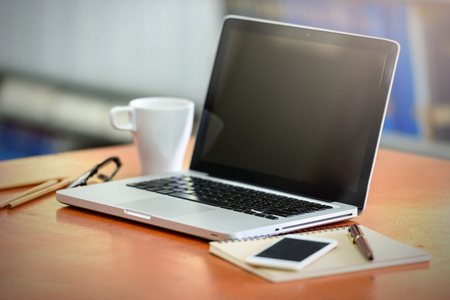 Notebook on the wood table in the room. Business and Technology Conceptsの写真素材