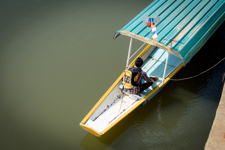 A young Asian backpacker tourist is enjoying a boat ride on the river.
Holidays and nature conceptsの写真素材