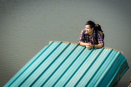 A young Asian backpacker tourist is enjoying a boat ride on the river.
Holidays and nature conceptsの写真素材