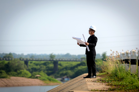 The engineer's eyes were closed, his mind working, his hands on the blueprint.の写真素材