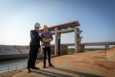 Business men meeting with Engineers and foremen are standing reading reports on construction sites.の写真素材