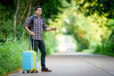Backpacker is hitchhiking.の写真素材