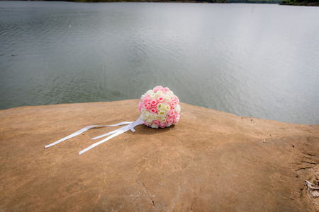 Bouquet on a rock near the river.の写真素材