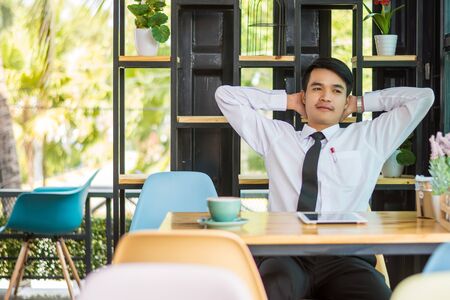 Businessman relaxing in a cafe.の写真素材