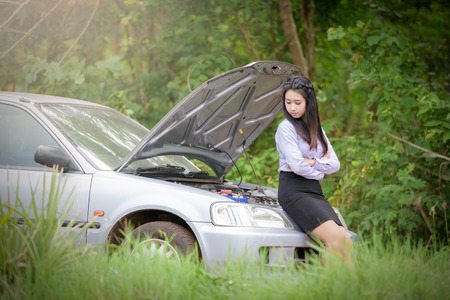 Asian businesswoman on the street She has problems with her car.