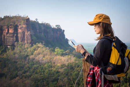 Close up Tourist young woman  looking location on tablet to the mountain, woman reading map. Tourism...