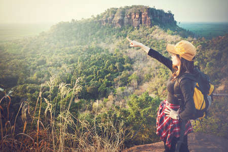 Backpackers or Hikers Tourists Female enjoying in nature and looking far to the sky.