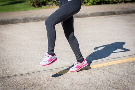 Woman jogging outdoor workout on park.の写真素材