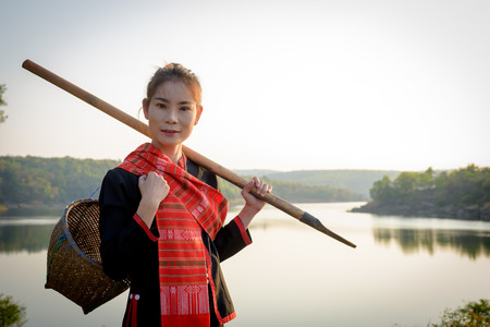 Phu Thai (Thai Language) girl stand on the rocks near the river.