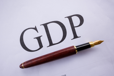 GDP words on the paper with a pen.の写真素材