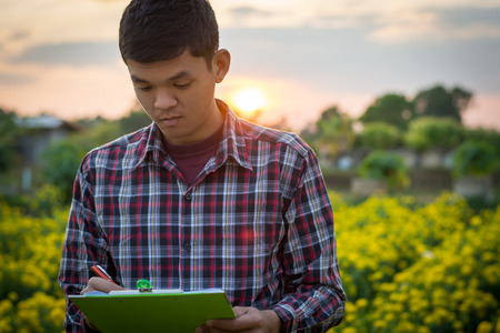 Farmers went to check marigolds in the garden.の写真素材