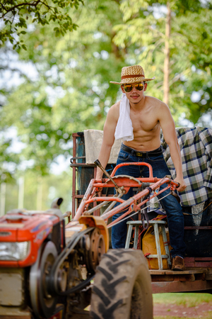 Farmers do not wear jackets, but jeans are driving plows.の写真素材